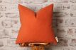 burnt orange and teal pillow
