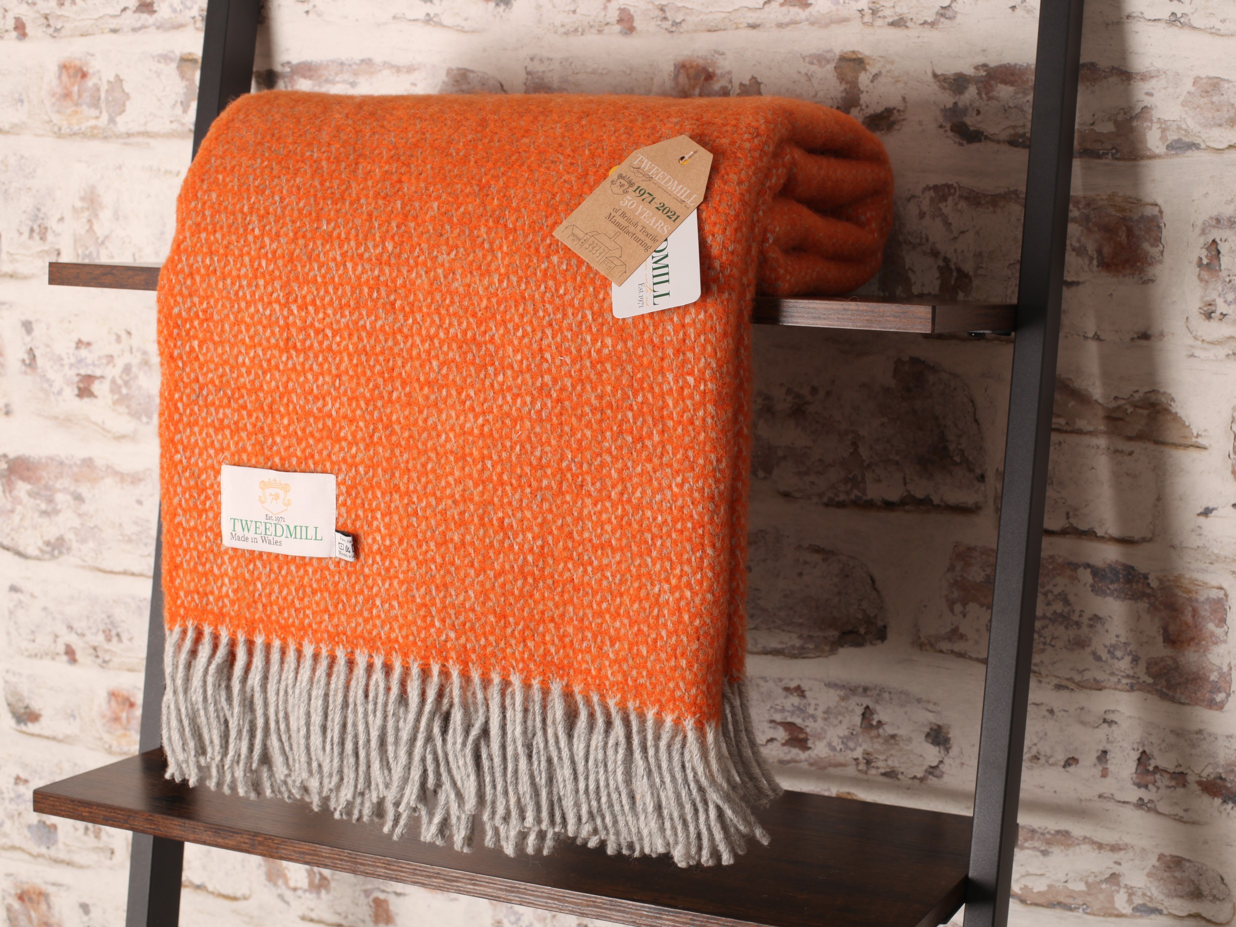 tweedmill orange and grey throw blanket